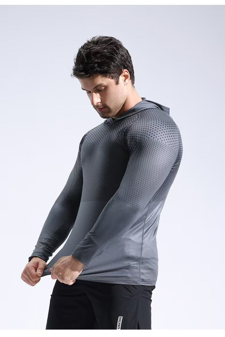 Man wearing a gray long-sleeve athletic shirt on a light gray background